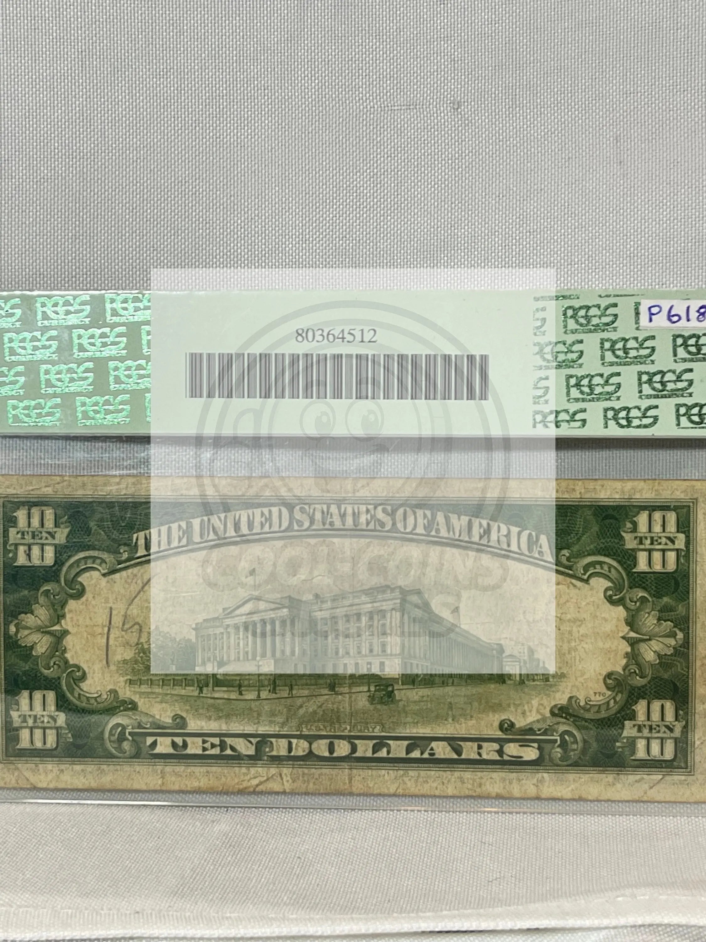 1934A North Africa Silver Certificate $10 US banknote graded PCGS Fine with yellow Treasury seal and moderate wear