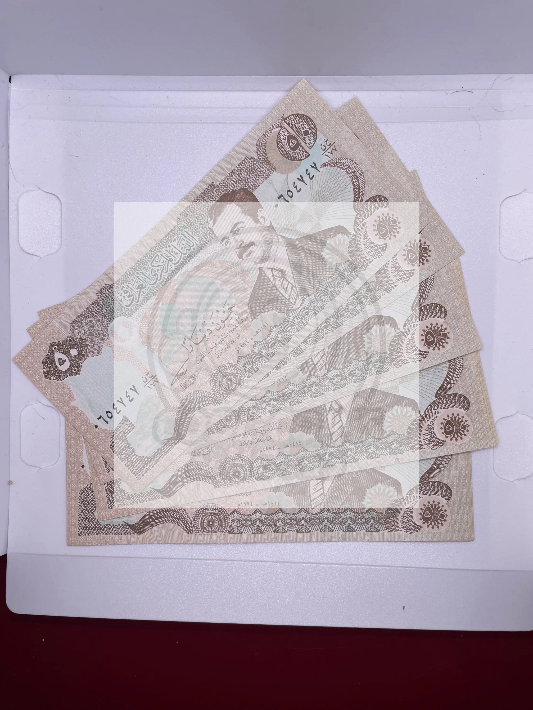 1986 Iraq 5 pieces 50 Dinars banknotes featuring Saddam Hussein with Swiss printing