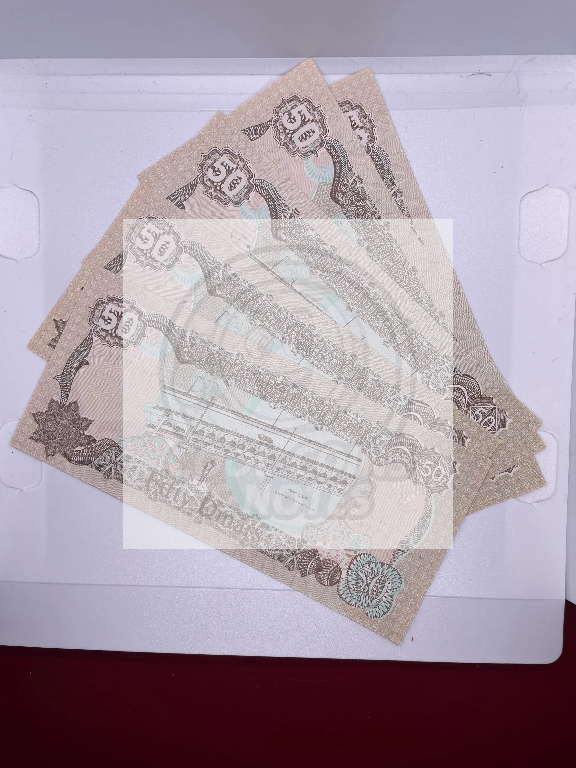 1986 Iraq 5 pieces 50 Dinars banknotes featuring Saddam Hussein with Swiss printing