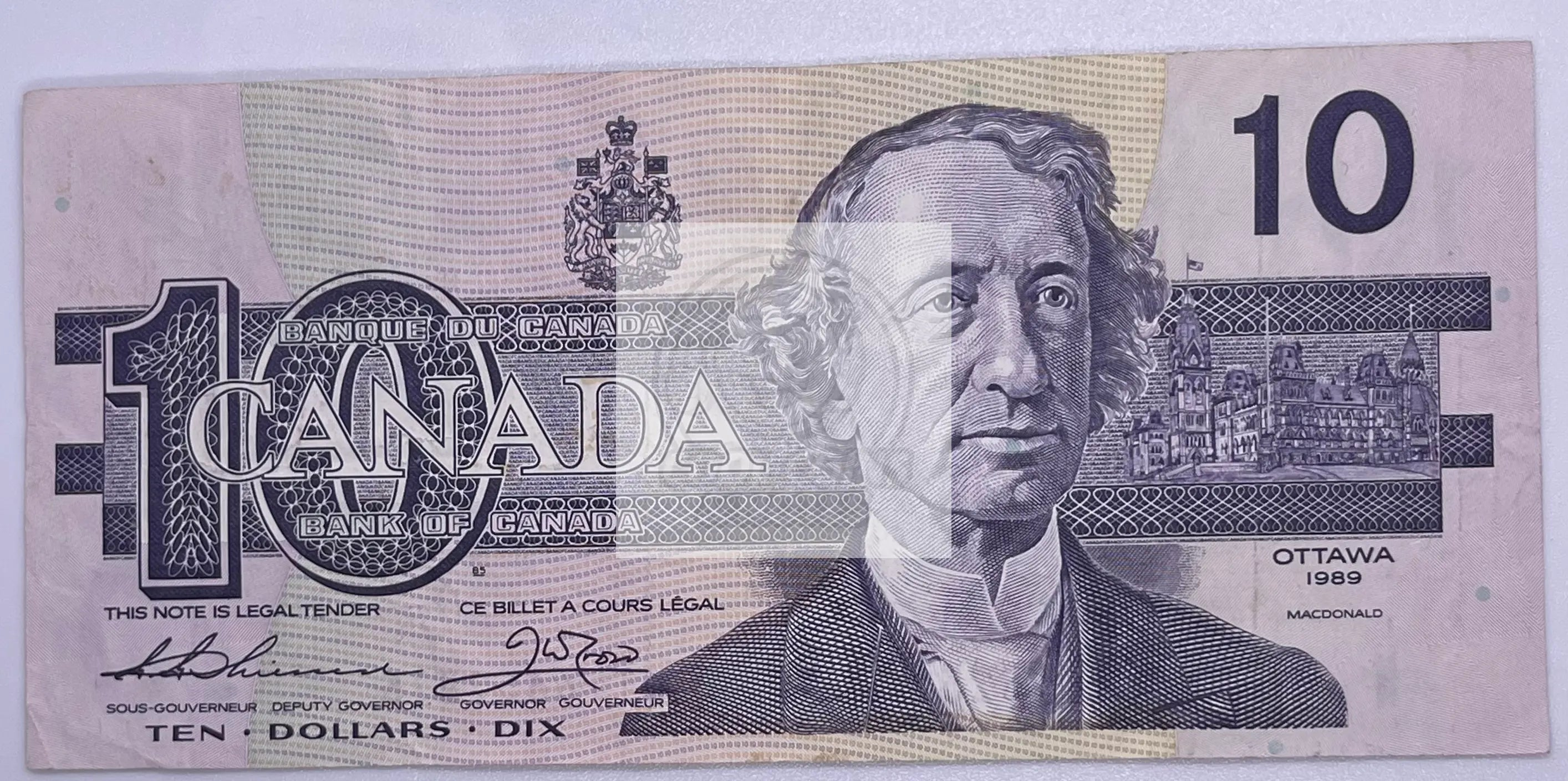 1989 Canada $10 banknote featuring Queen Elizabeth II with Bonin-Thiessen signature, showing signs of use and detailed Canadian designs