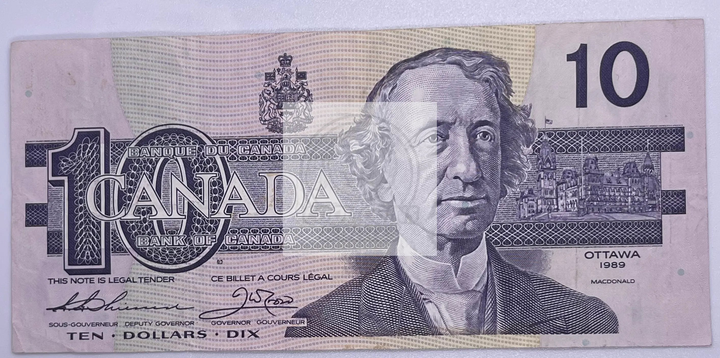 1989 Canada $10 banknote featuring Queen Elizabeth II with Bonin-Thiessen signature, showing signs of use and detailed Canadian designs