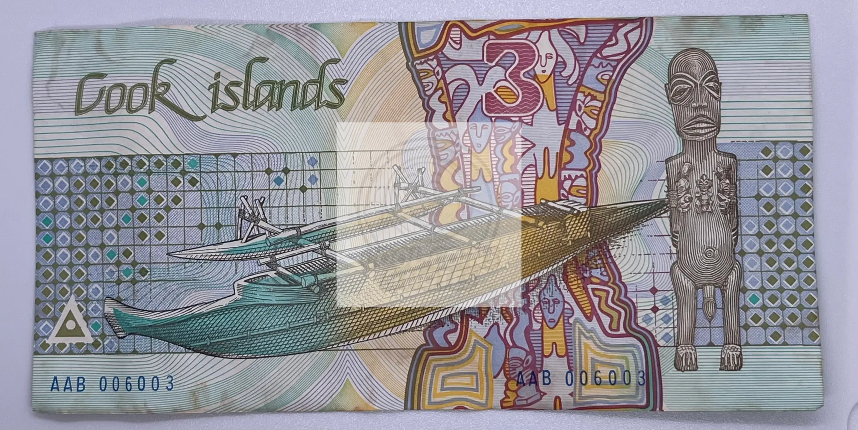 Cook Islands $3 banknote 1987 P-3a almost uncirculated with vibrant island-themed design and stains
