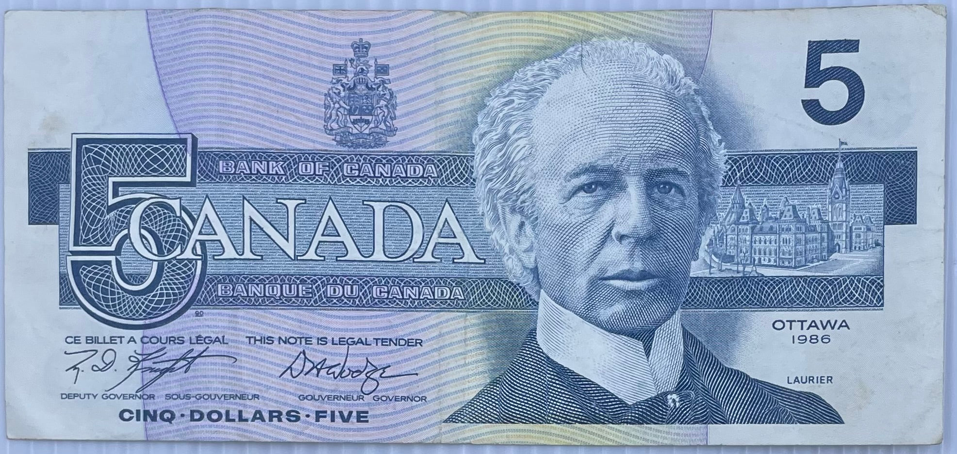 1986 Canada $5 bill featuring Sir Wilfrid Laurier with a tear on bottom left corner